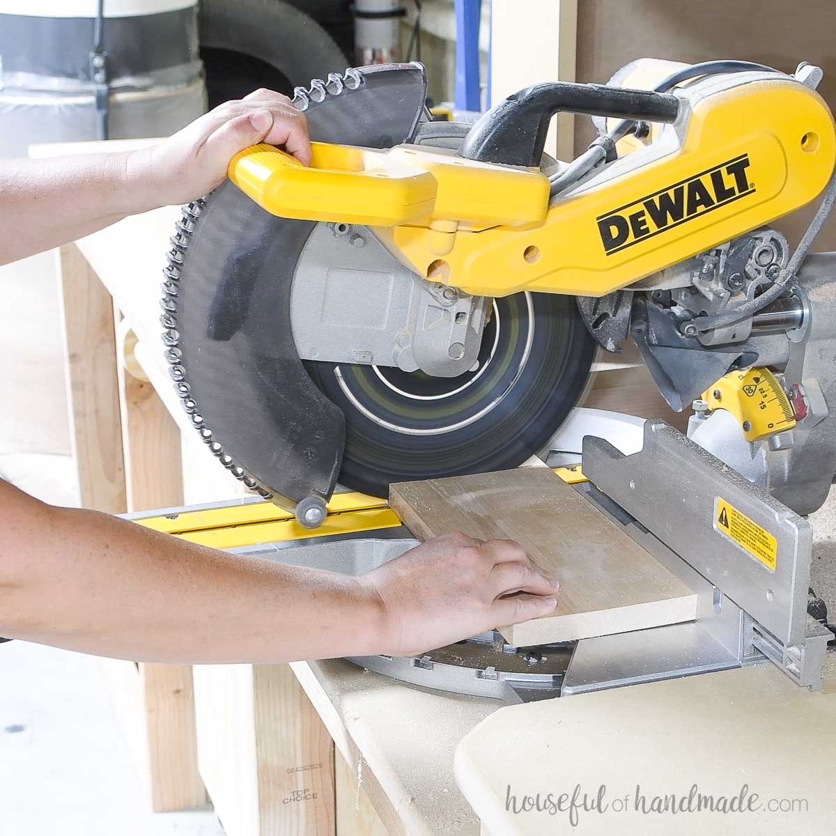 Cutting a 1x6 alder board on a miter saw.