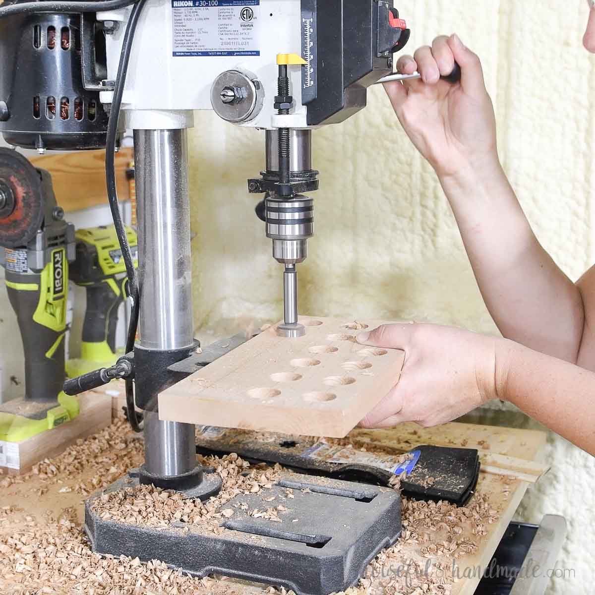 Drilling holes with a forstener bit on a drill press.