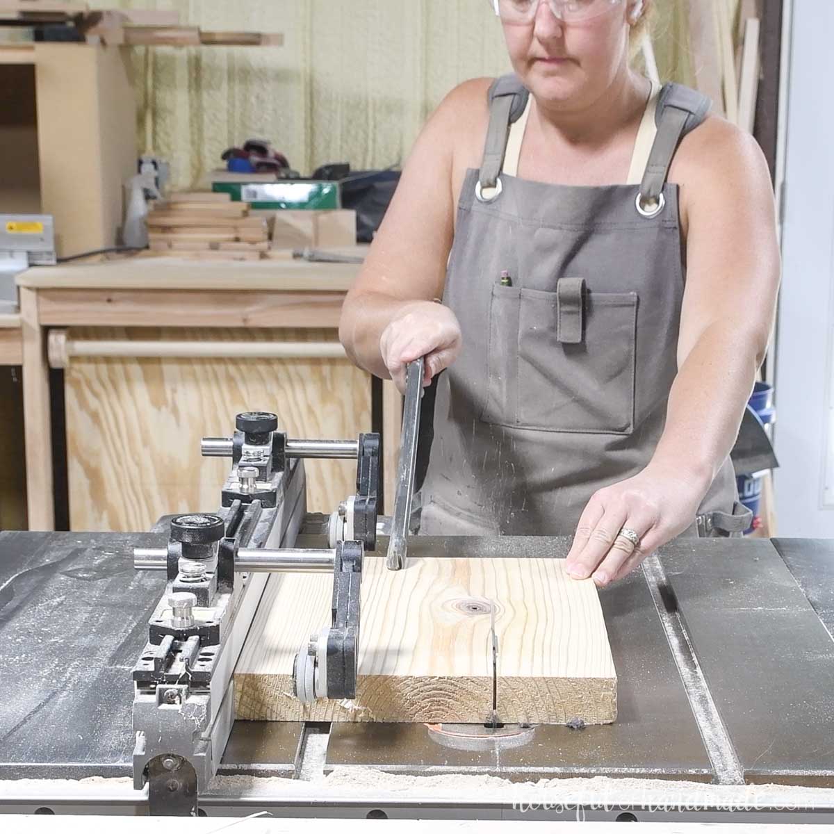 Ripping a 2x board to width on a table saw. 