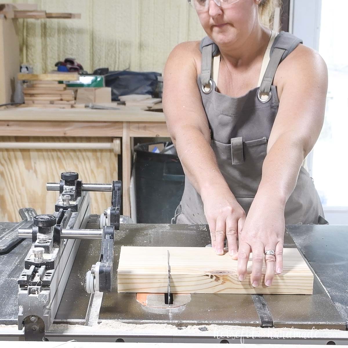 Cutting a 2x board to length on a table saw. 