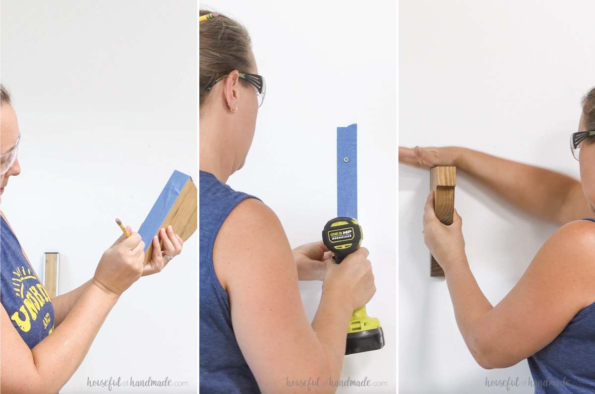 Attaching shelf brackets to the wall with painters tape to mark keyhole spots. 