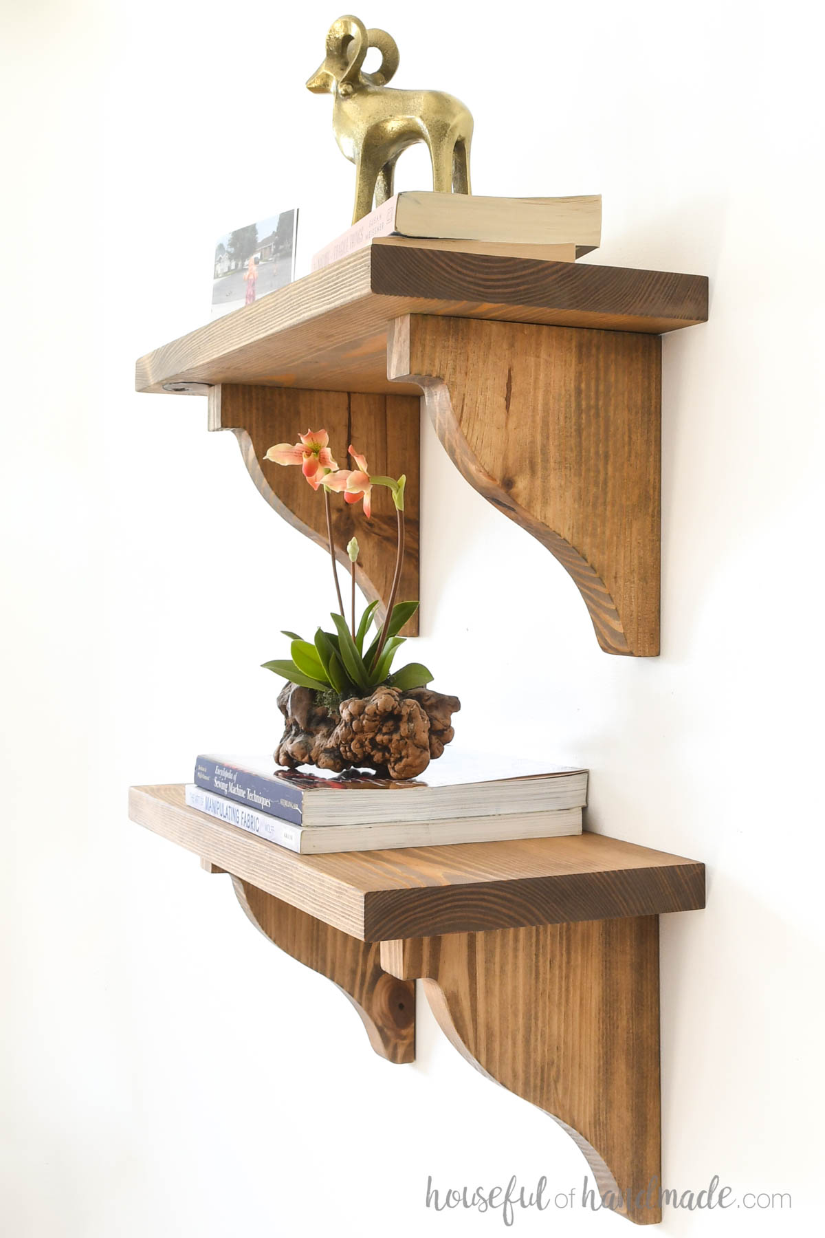 Wood corbels made from pine and stained warm wood with weathered undertones holding shelves. 