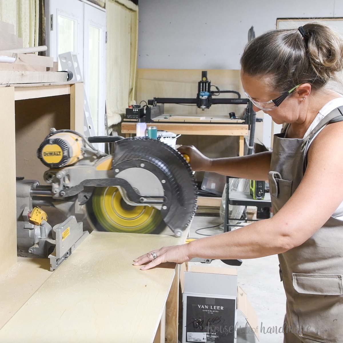 Cross-cutting the plywood pieces with a sliding miter saw. 