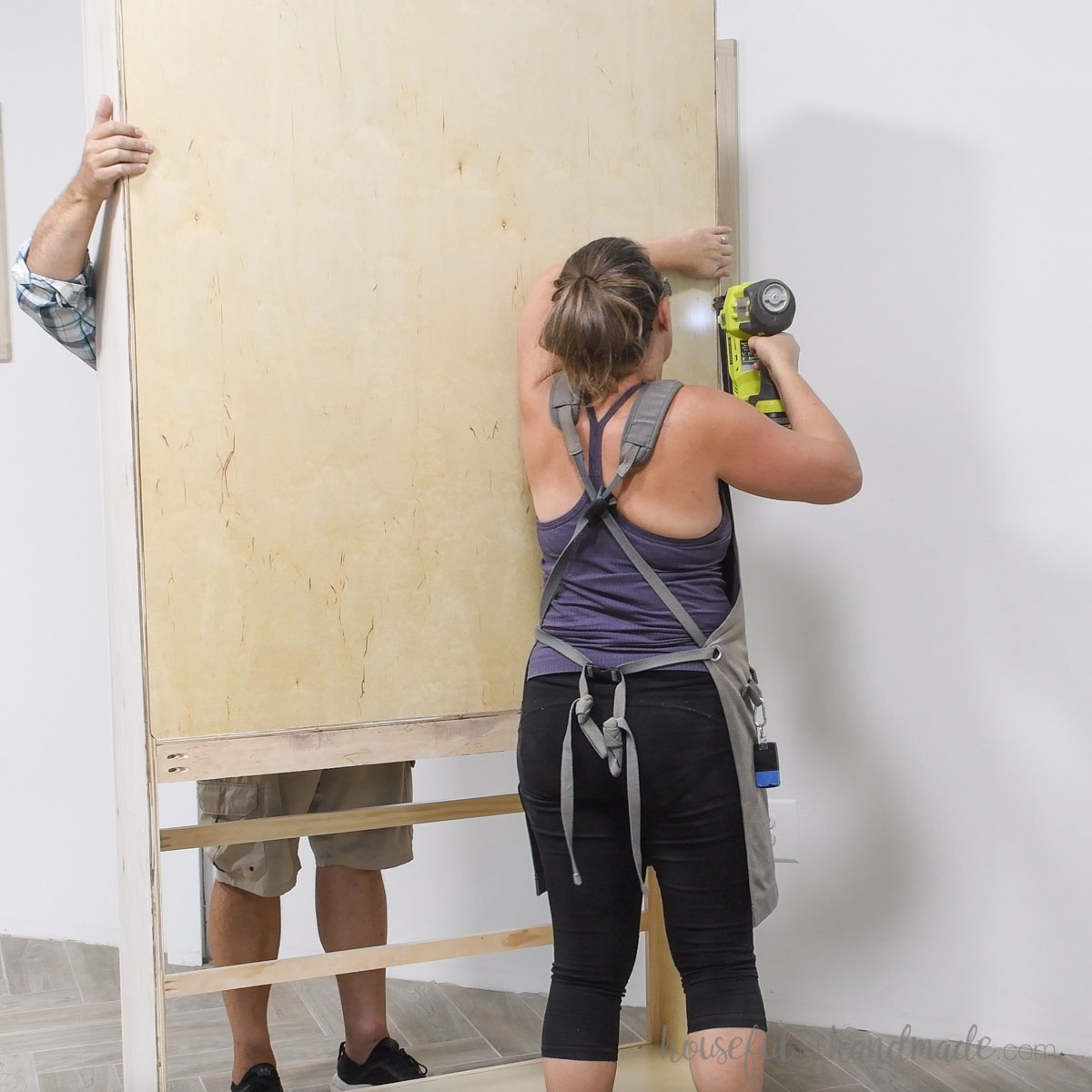 Attaching the back to the tall bookcase with brad nails. 