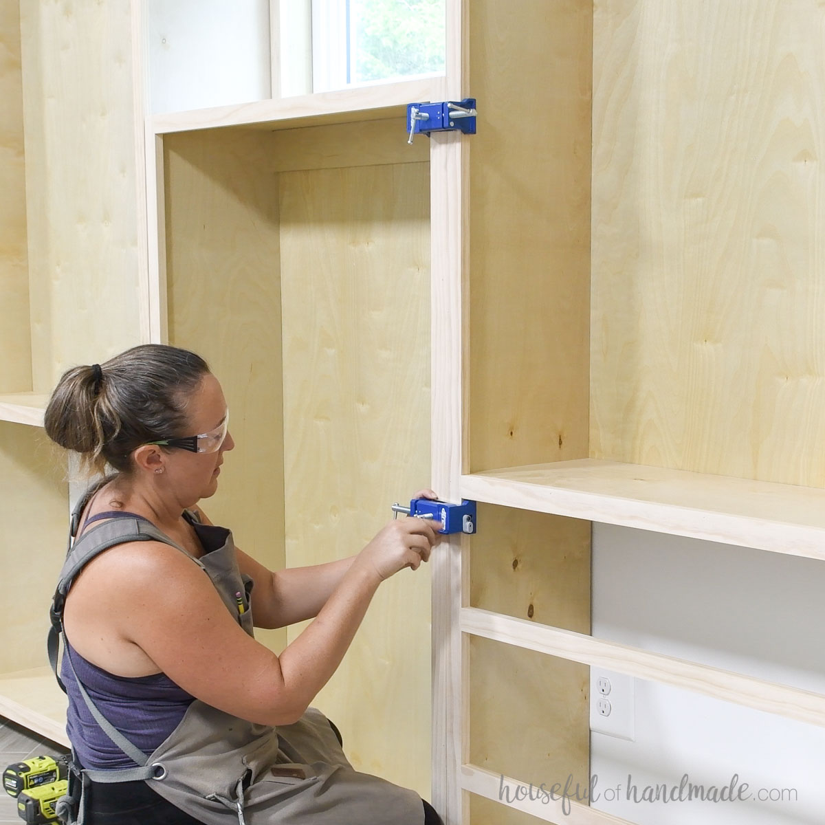 Attaching the cabinets together with cabinet clamps. 