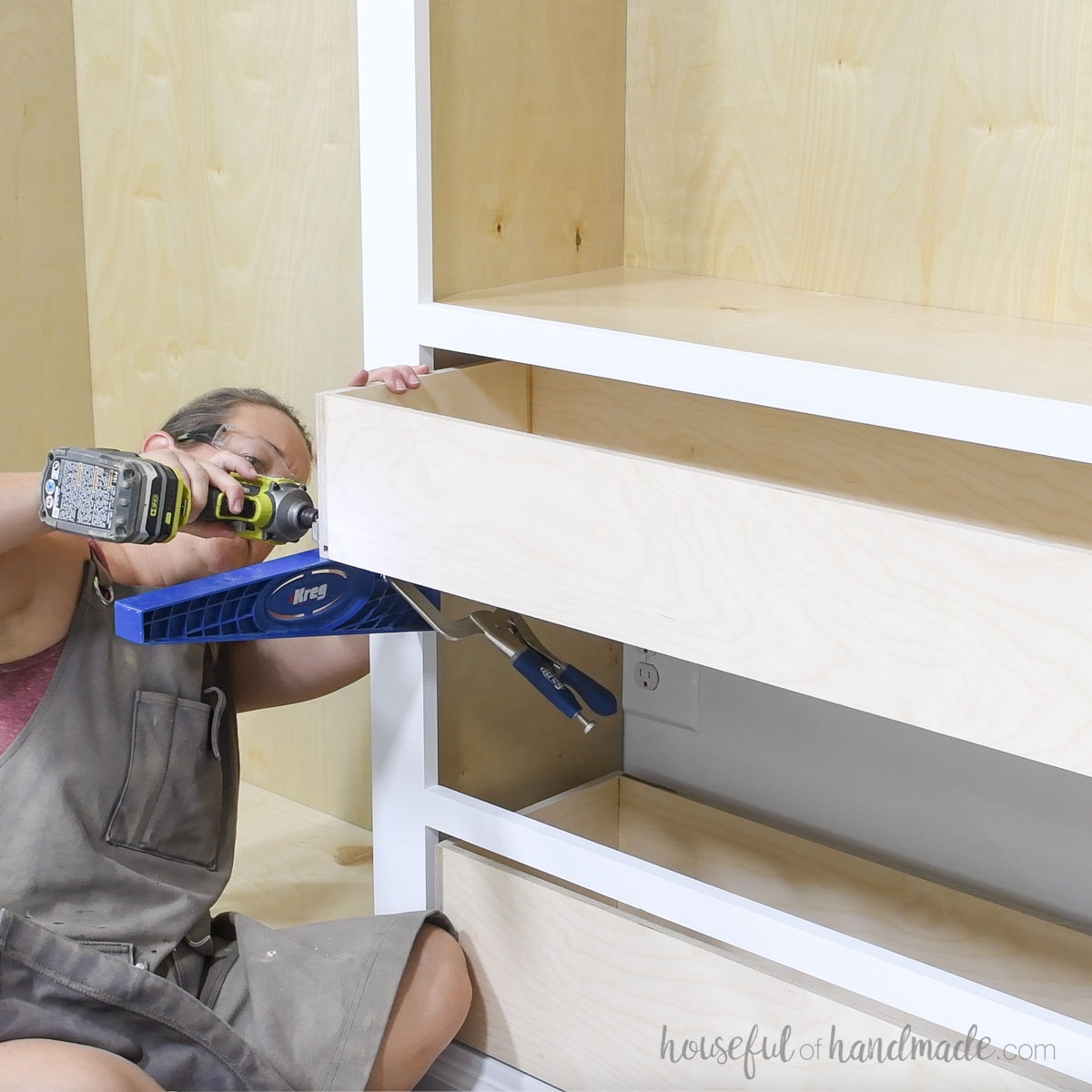 Installing the drawer boxes inside the bookcase. 