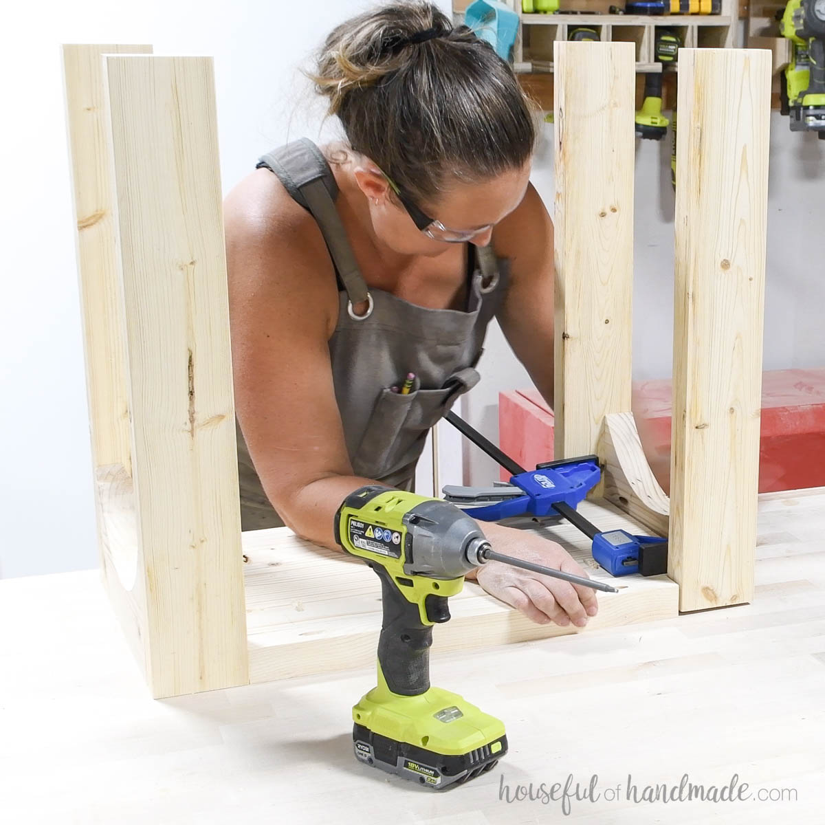 Using a clamp as a spreader to make room for the assembled top. 