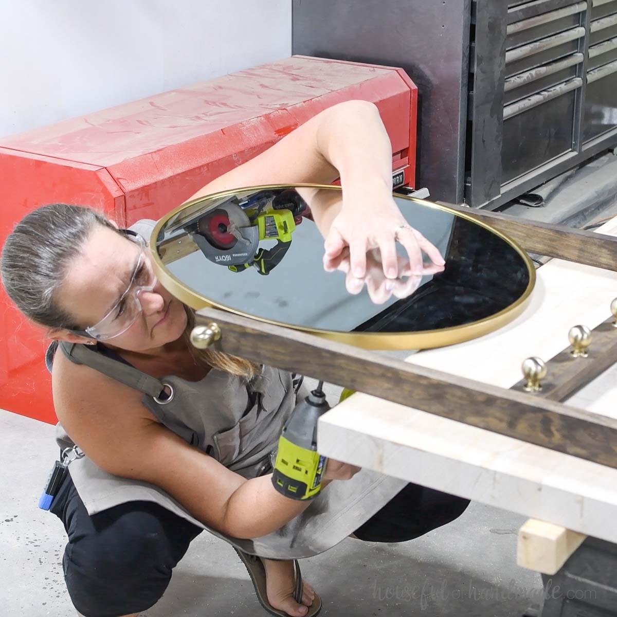 Attaching the mirror to the top of the entry ladder. 