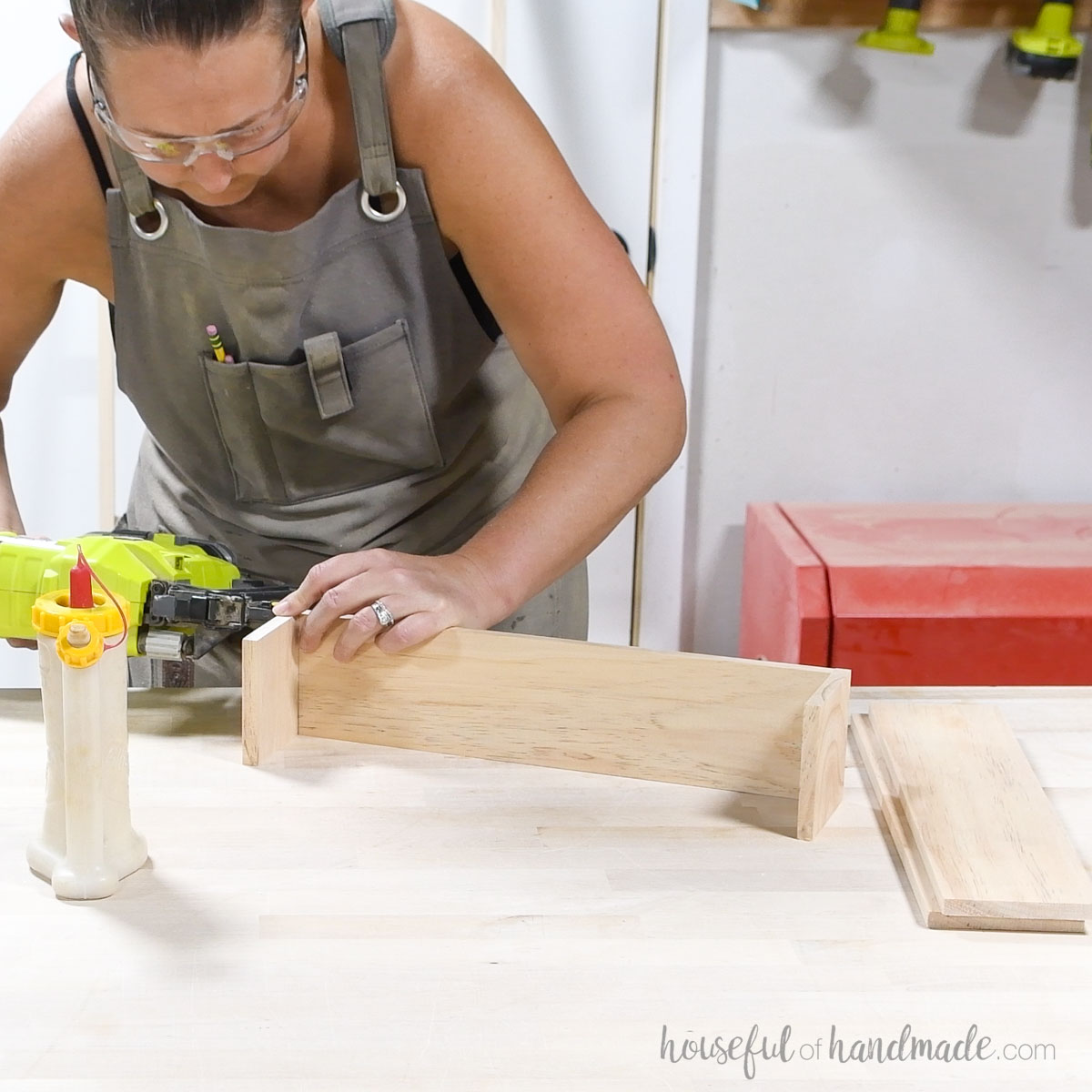 Attaching the sides of the bin to the bottom with brad nails. 