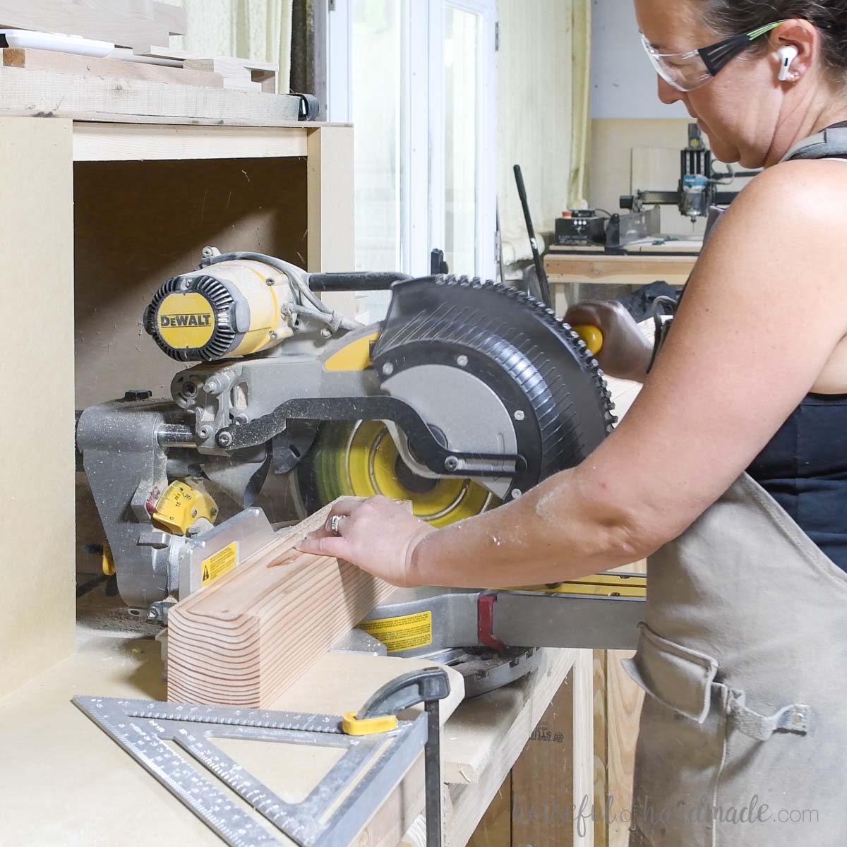 Cutting a 4x4 board on a miter saw. 