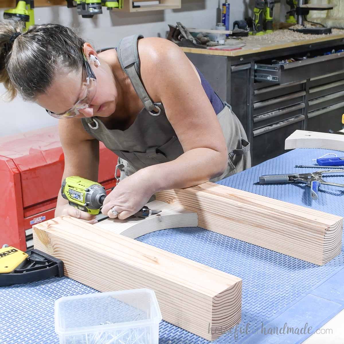 Attaching arched board between two chunky legs with pocket hole screws. 