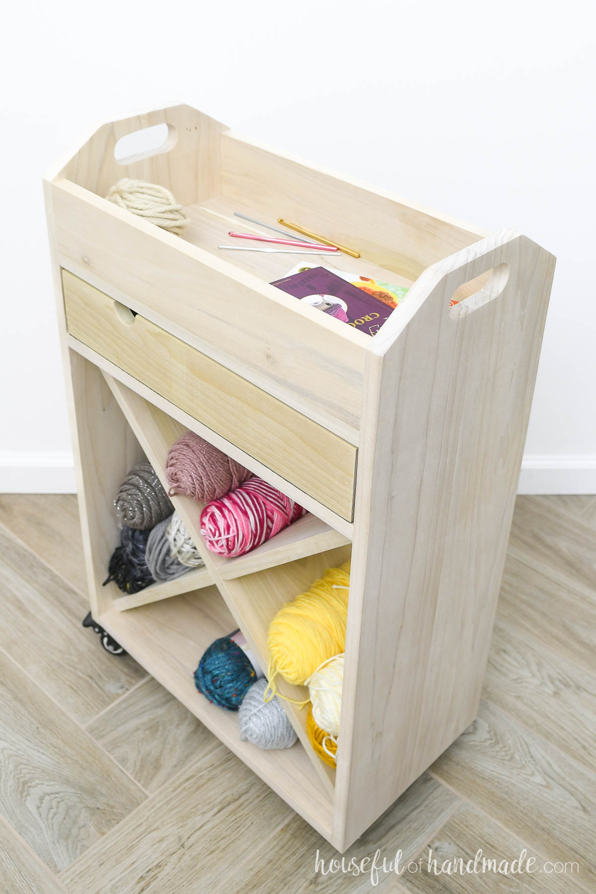 Wooden cart for crafts with yarn storage and drawer and tray for current project. 