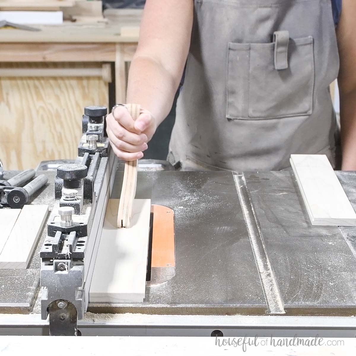 Cutting a groove in the bottom of the tray pieces on a table saw. 