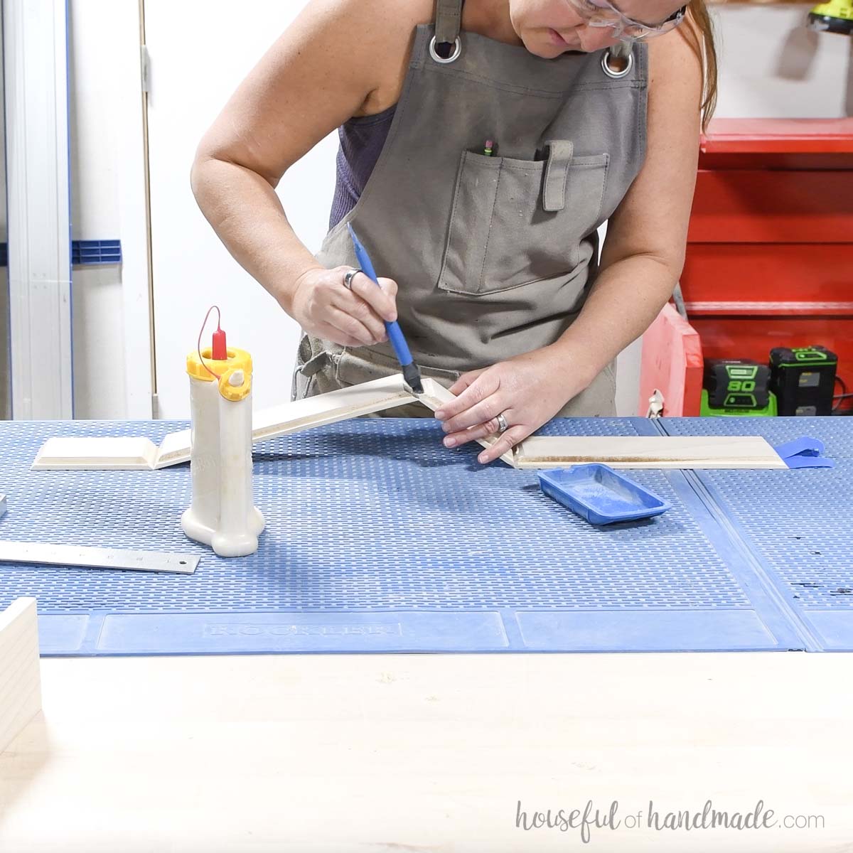 Adding glue the mitered corners of the tray pieces. 