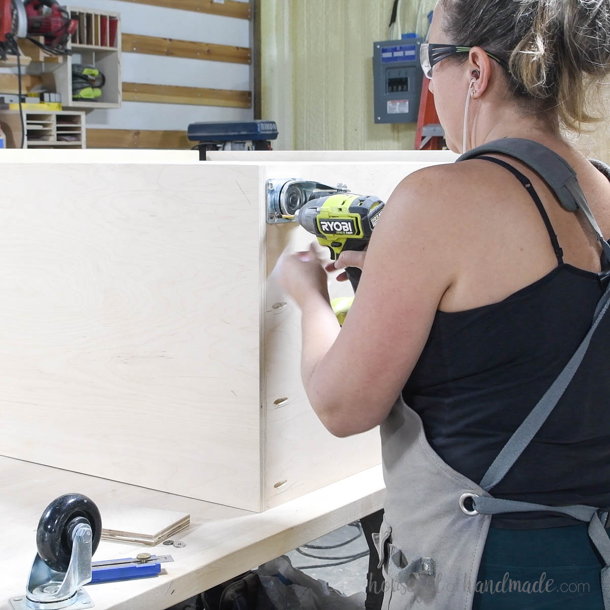 Attaching castors to the bottom of the wrapping paper cart. 