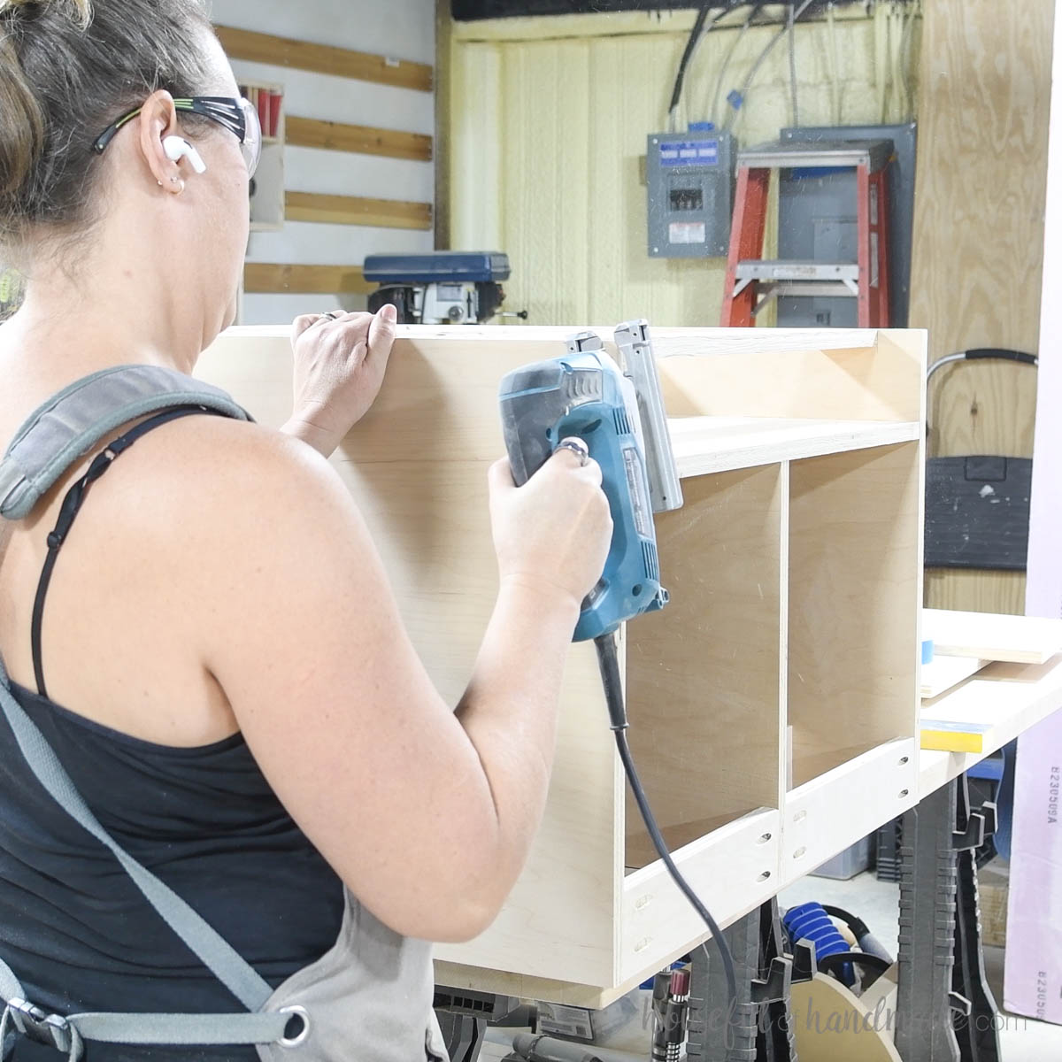 Rounding the corner of the plywood piece with a jig saw. 