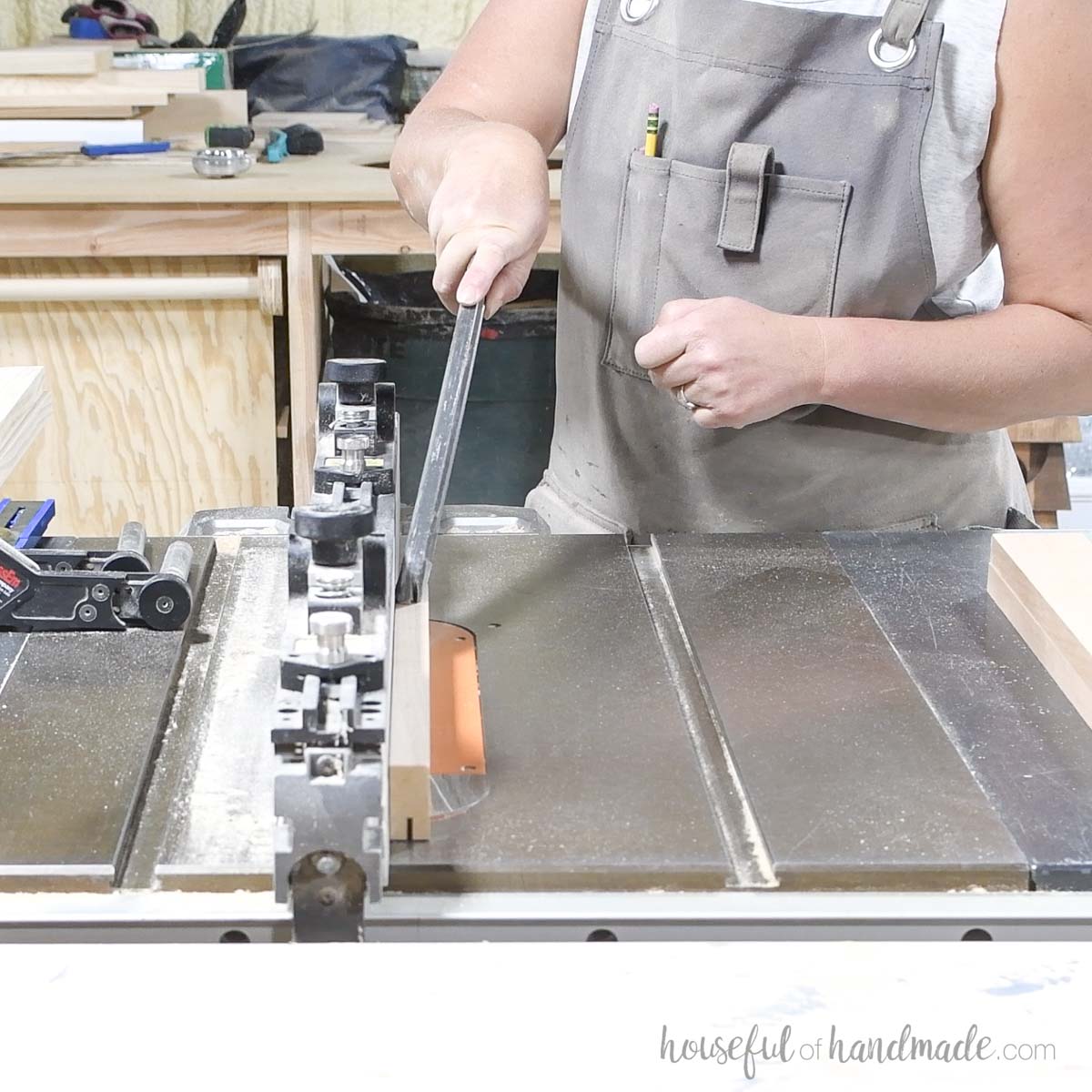 Cutting a groove in the top of a 2x3 boards with a table saw. 