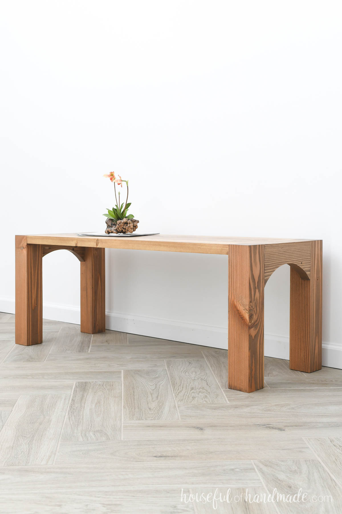 Simple coffee table with chunky legs stained medium brown. 