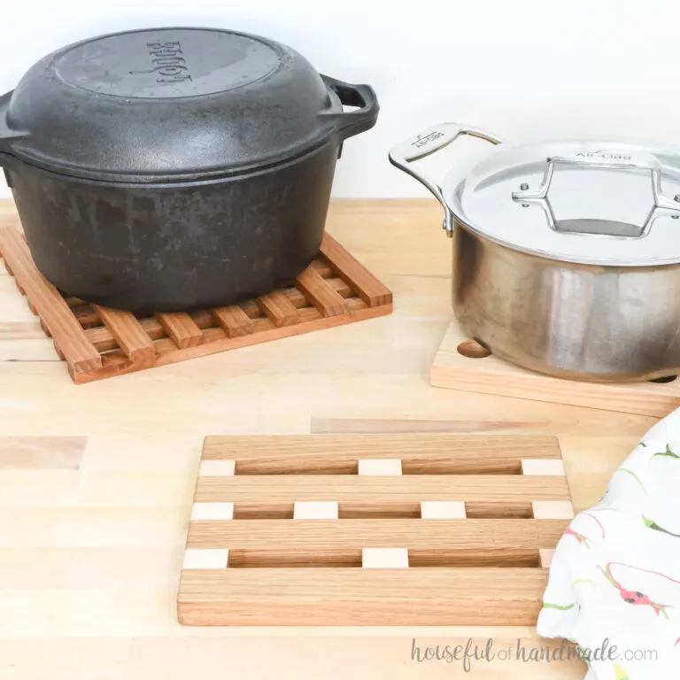 Three DIY wood trivets, two with pans sitting on top of them.