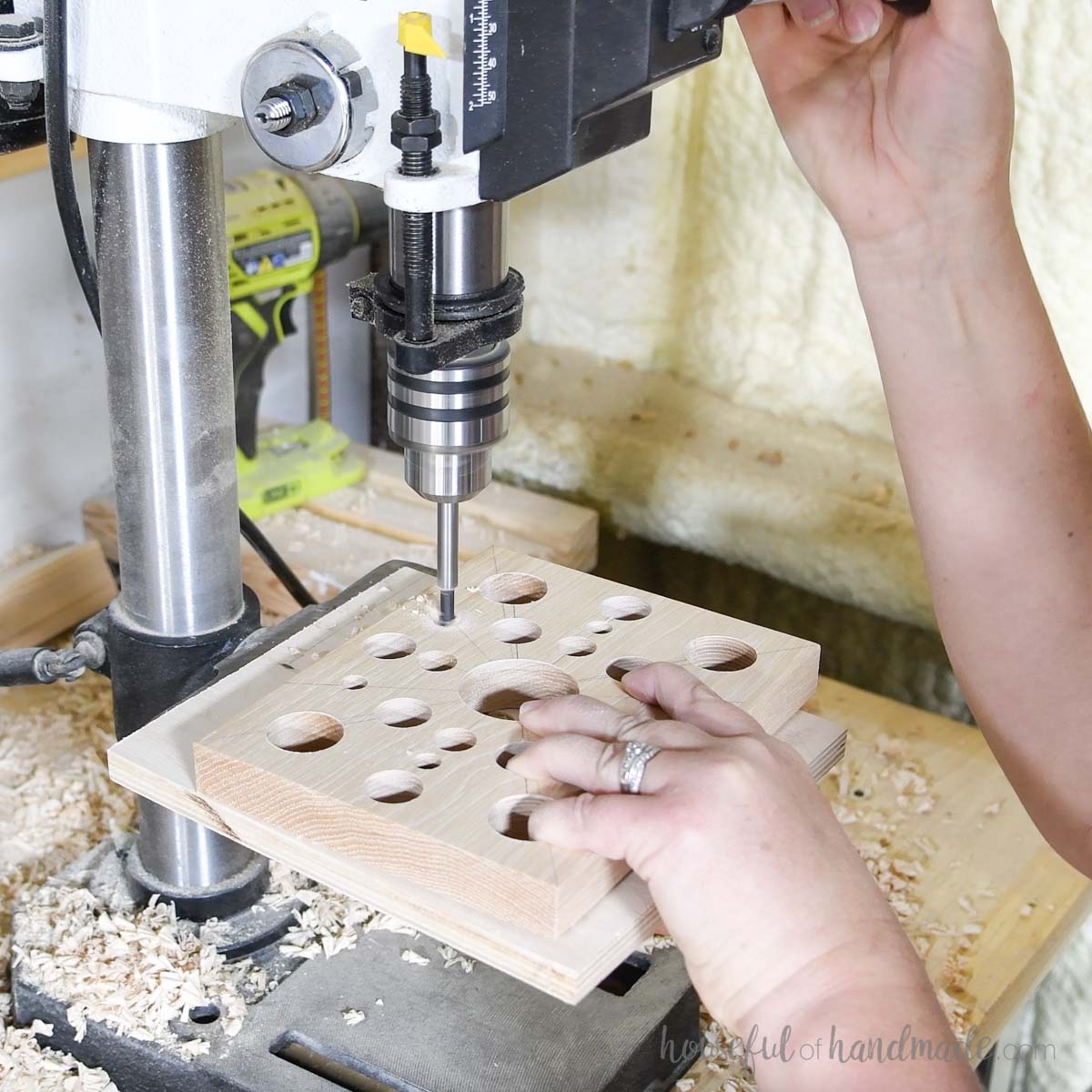 Filling in between the bigger holes with smaller holes using a drill press. 