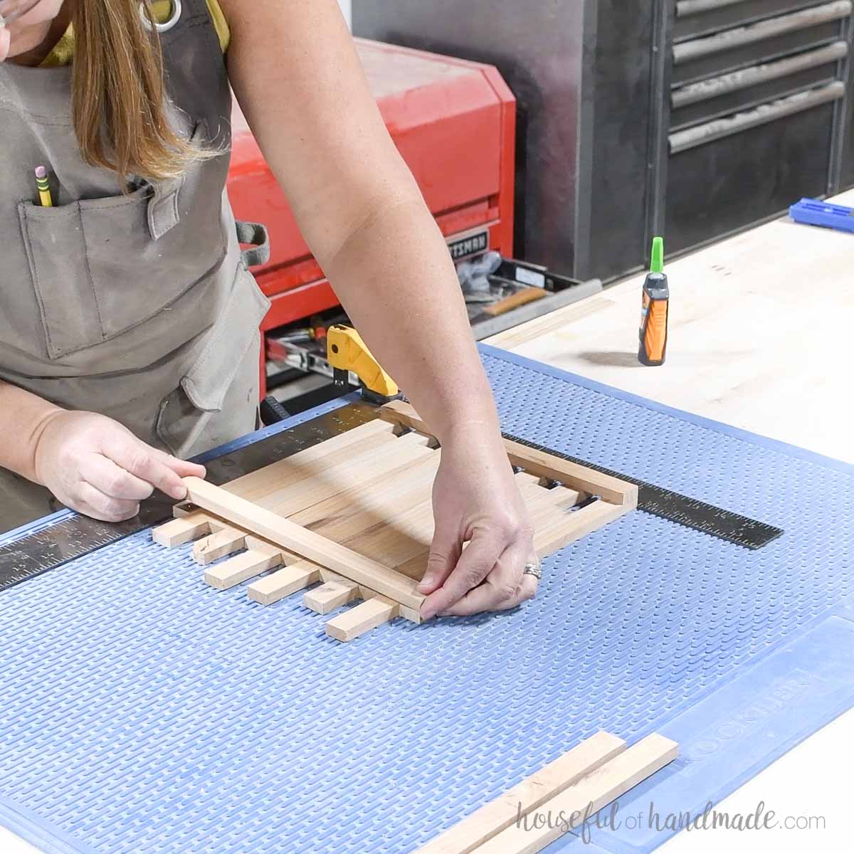 Glueing the second side piece to the bottom pieces. 