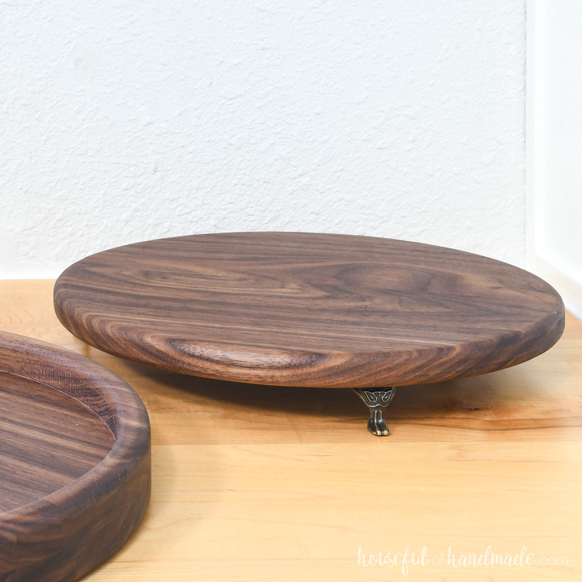 Walnut round tray with metal feet. 