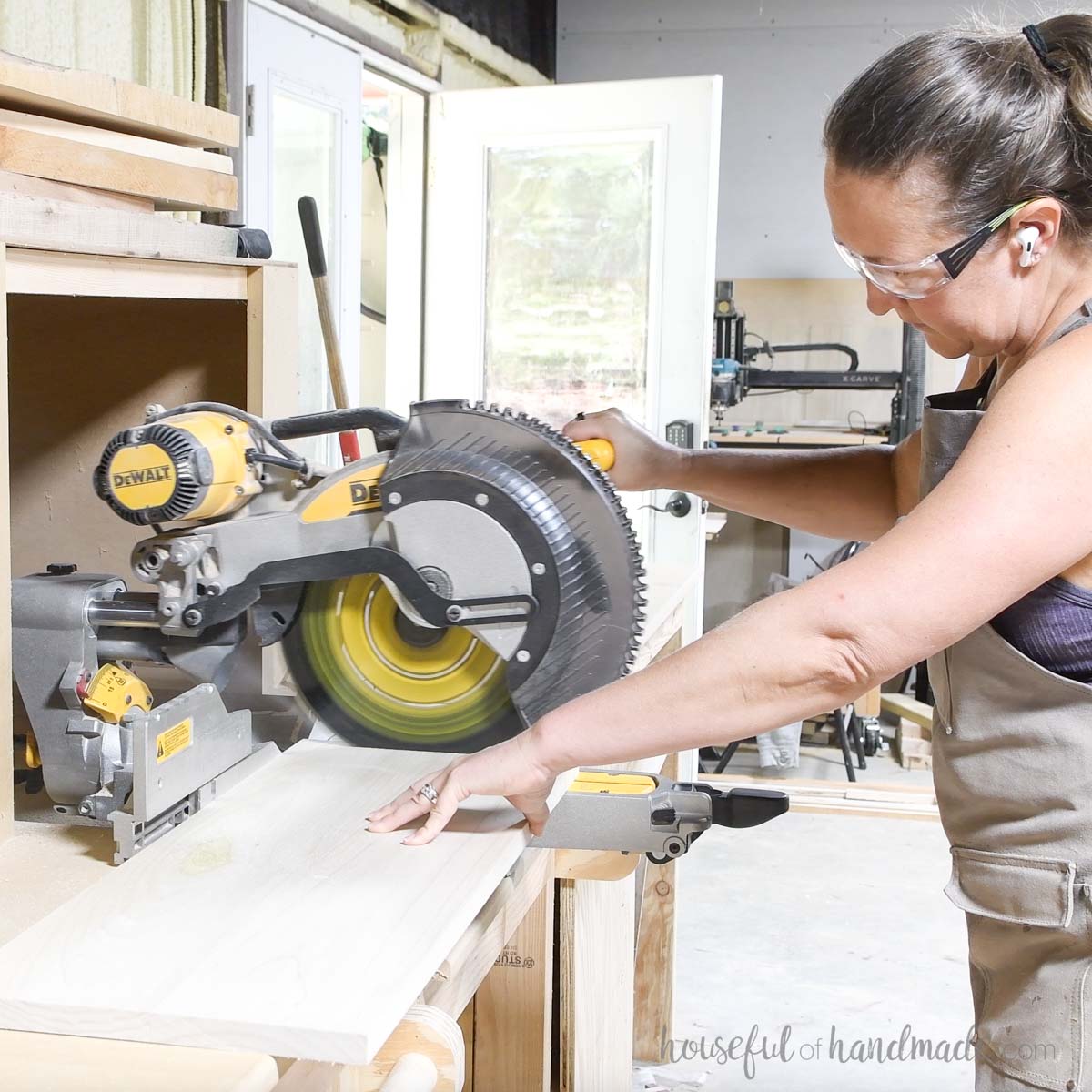 Cutting a 1x12 board on a miter saw. 