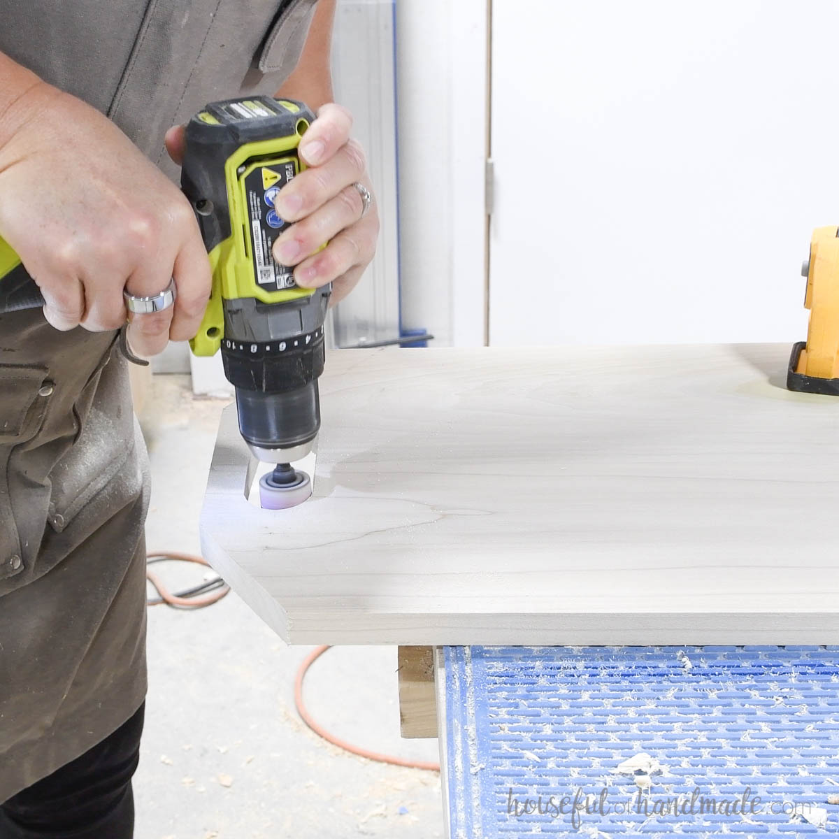 Using a drill sanding attachment to sand inside handles. 