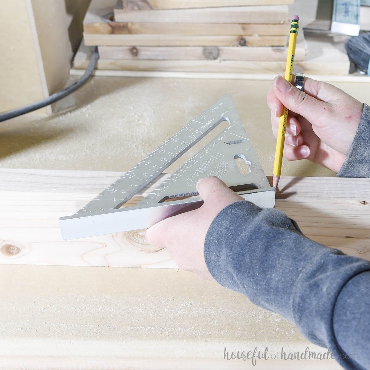 Drawing an angle with a carpenters square on the short edge of a 2x4 board. 