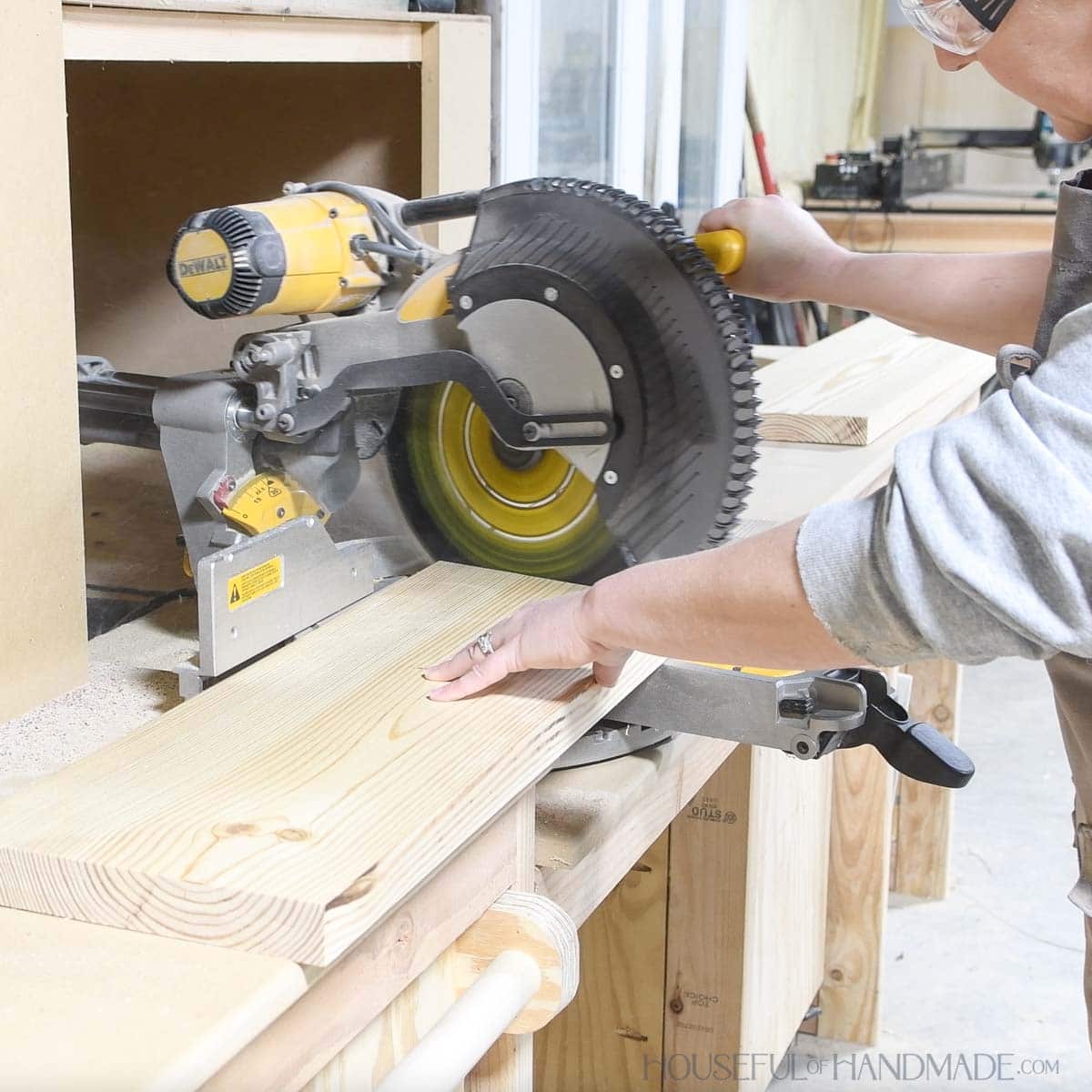 Cutting a 2x10 board at an angle on a sliding miter saw. 