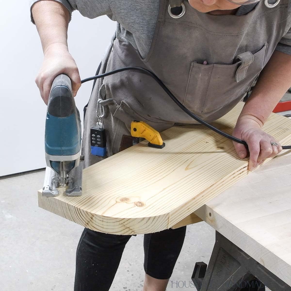 Cutting a curve in one side of a board with a jig saw. 