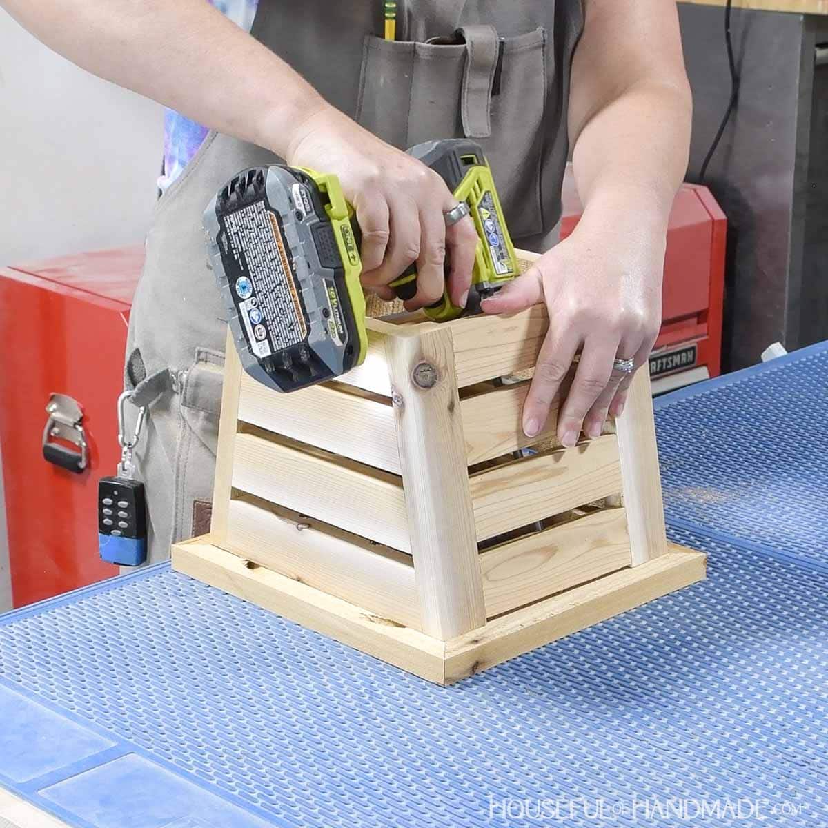 Attaching the planter base to the top frame. 