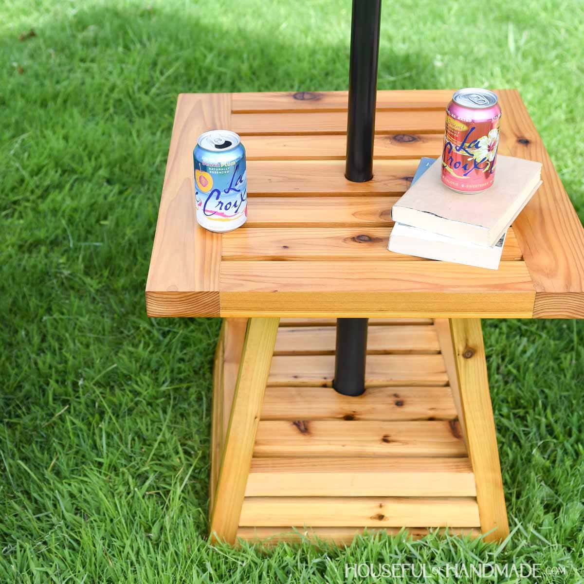 DIY cedar side table with Waterlox Marine finish sprayed on the surface.
