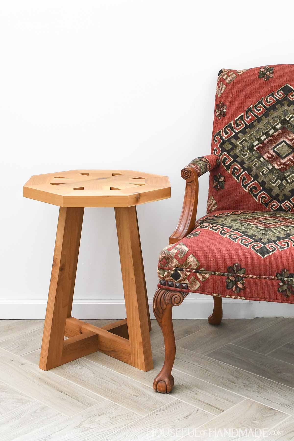 Wood end table with octagon round top and tapered legs.
