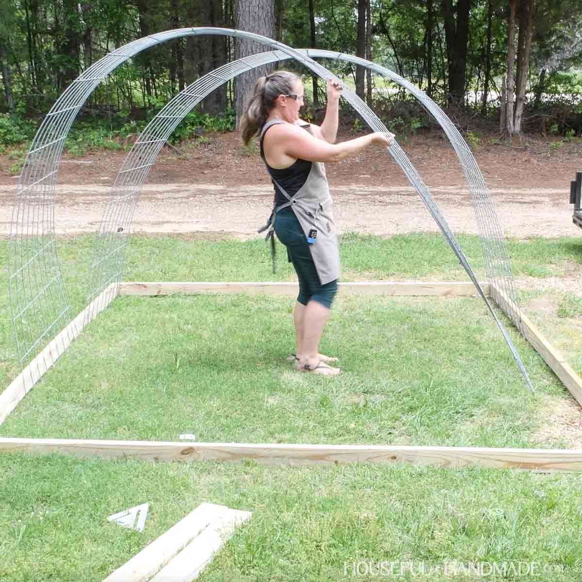Adding cattle panels inside the frame to create a hoop on top.
