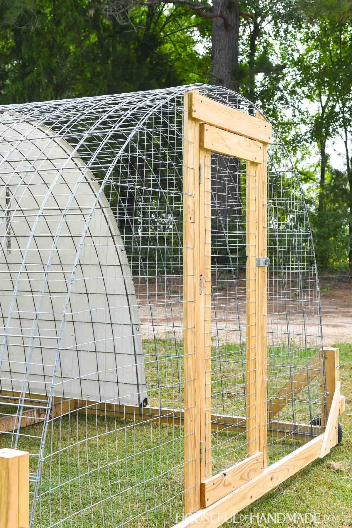 Close up of the large door on the mobile poultry house made with cattle panel fencing.