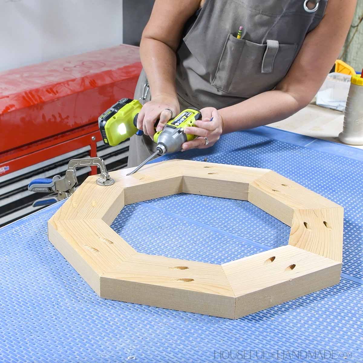 Adding the 8th piece into the wood octagon.