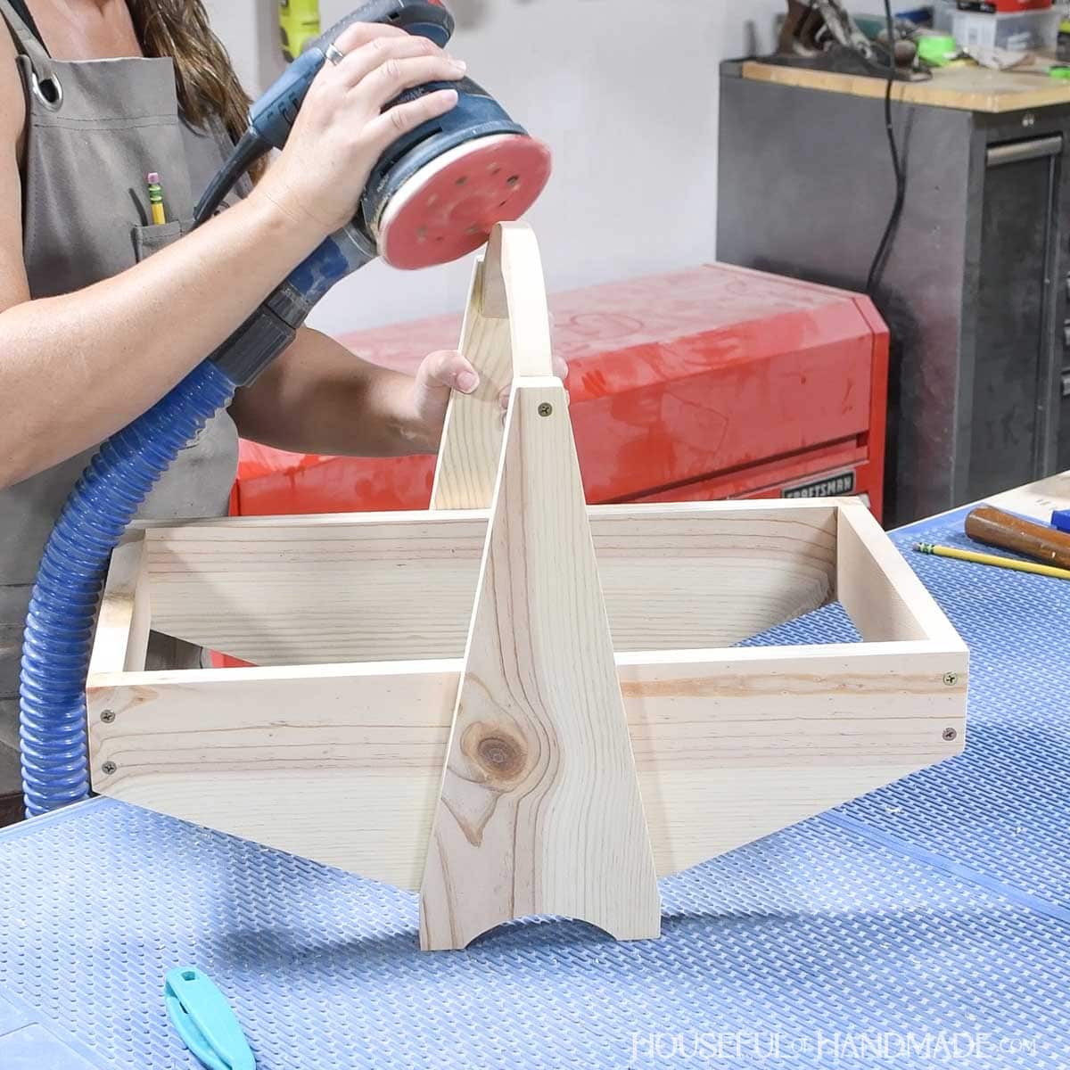 Smoothing the corner of the handle with a sander.