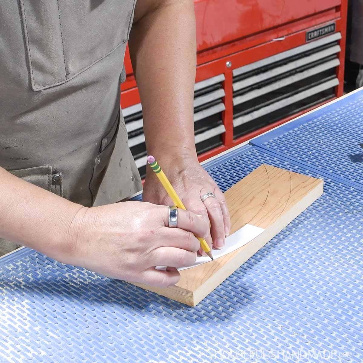 Tracing handle template on the board.