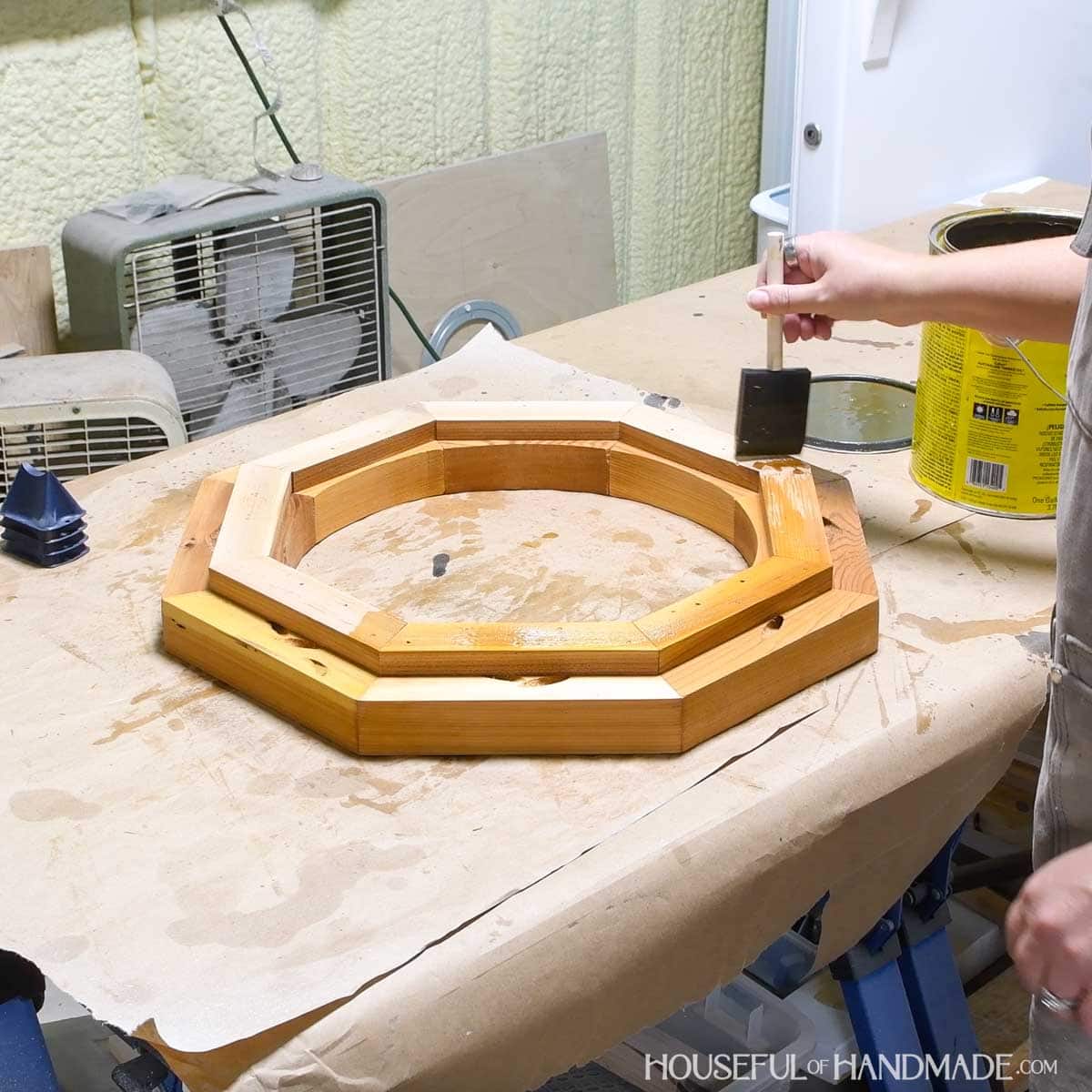 Sealing the birdbath with an outdoor sealer.