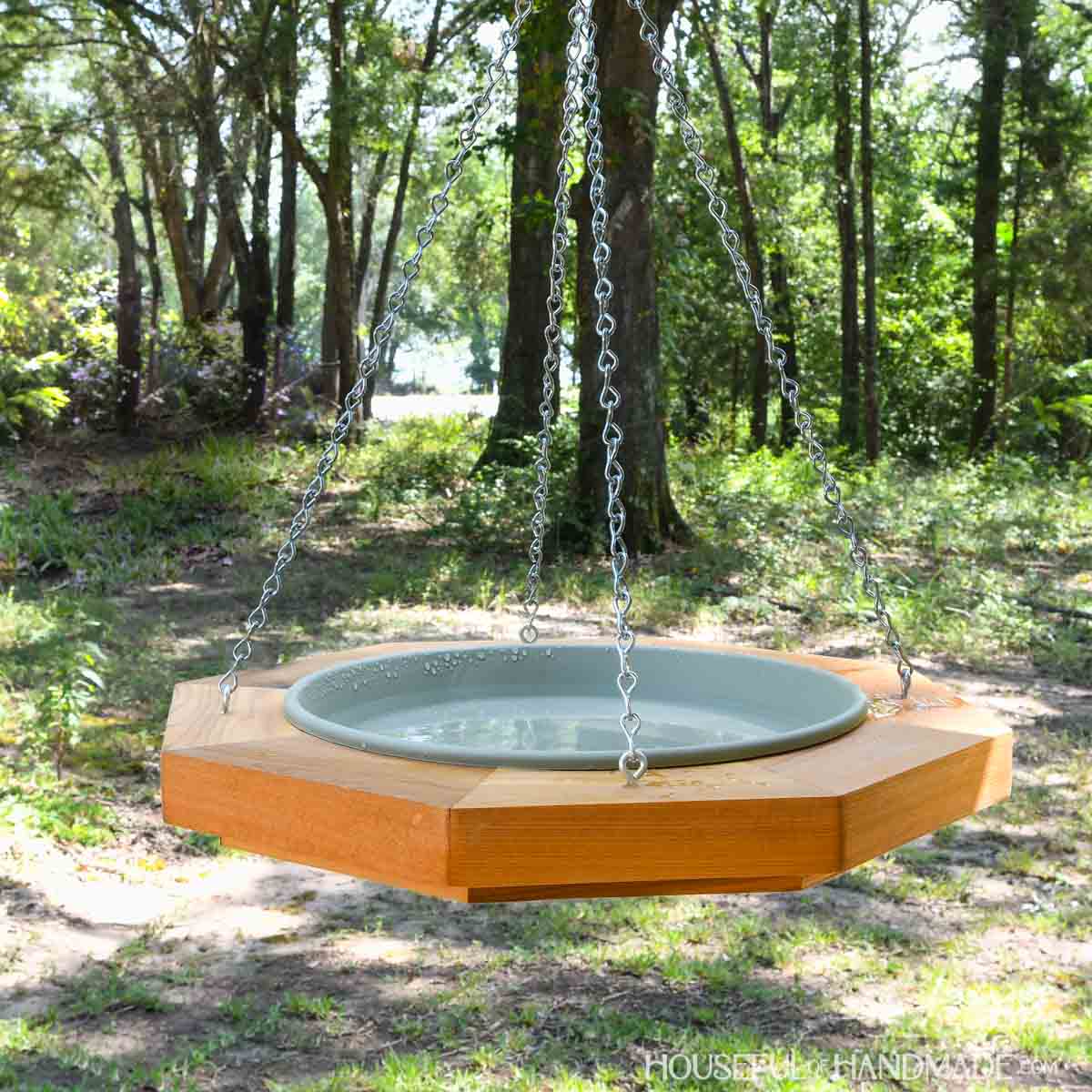 DIY hanging birdbath with plant saucer holding water inside.