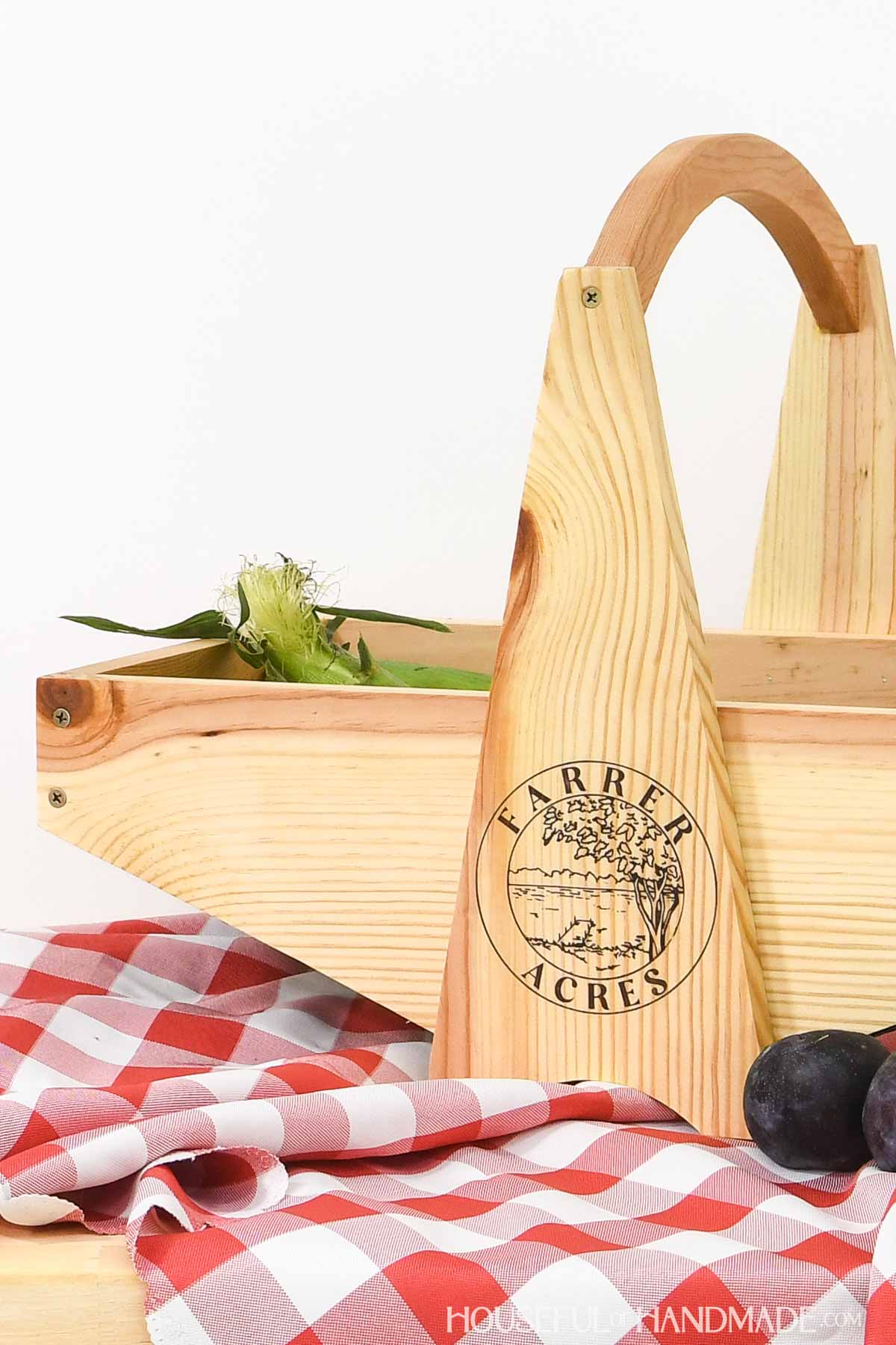 Large harvest basket with center handle and farm logo on the front.