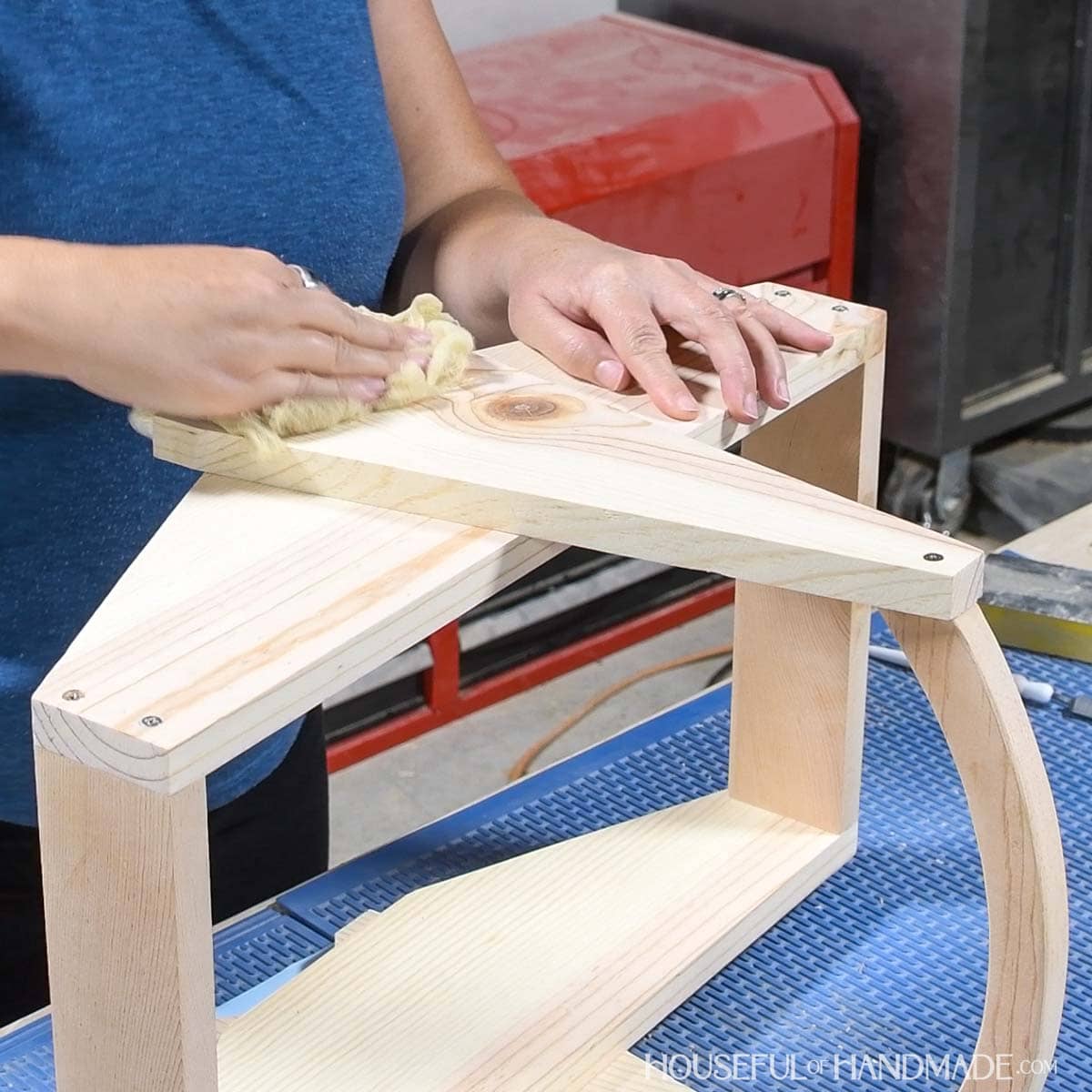 Wiping the top board in the project with a tack cloth. 