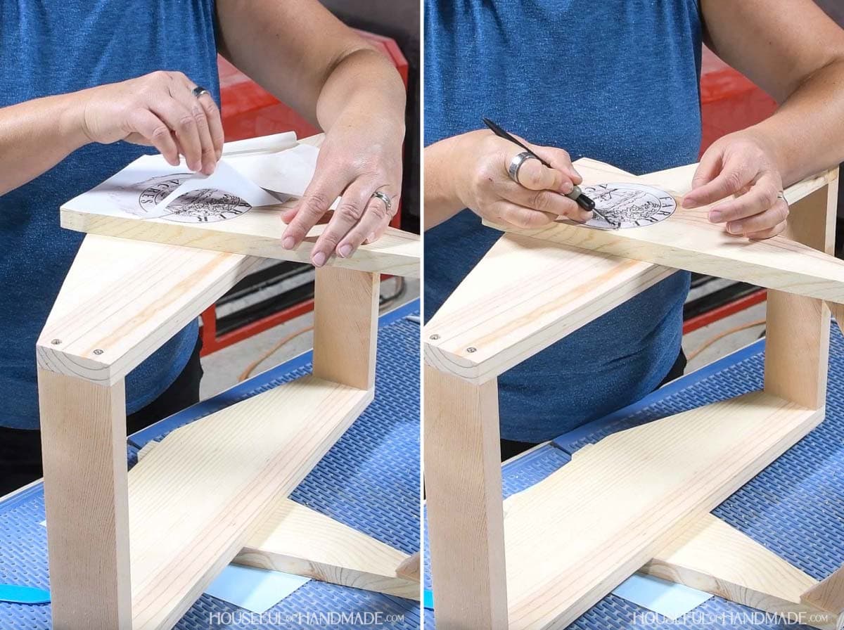 Removing the vinyl stencil from the wood board. 