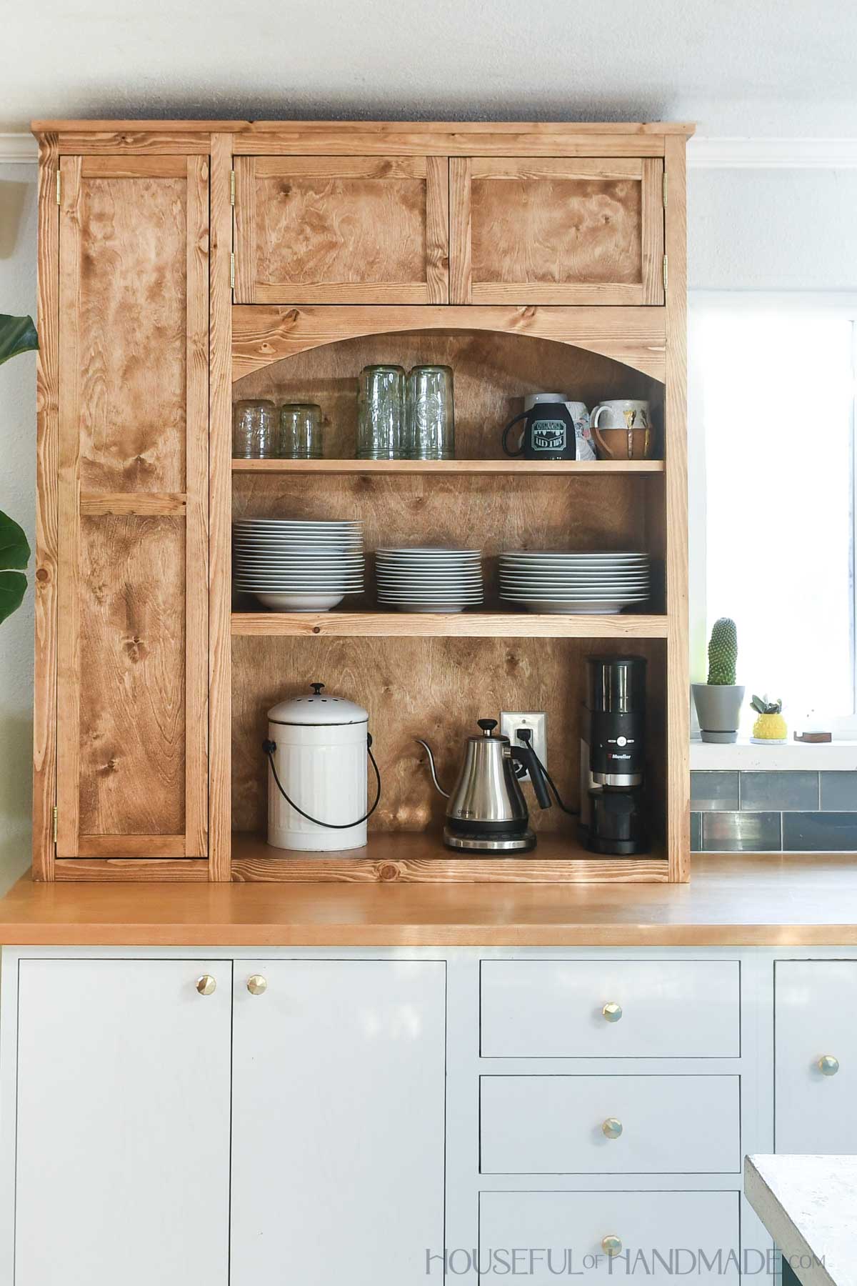 Large kitchen hutch with small cabinet on one side for appliances and lots of shelves. 