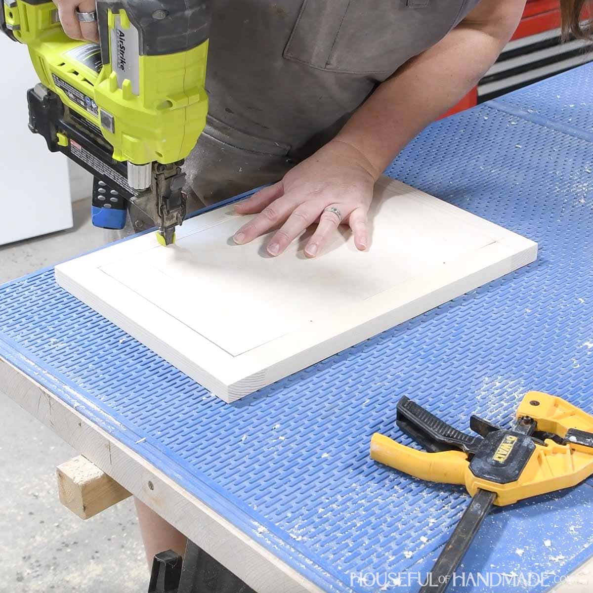 Attaching the door panel with brad nails. 
