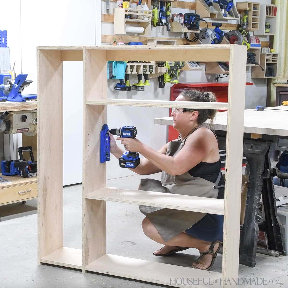 Drilling shelf pin holes with a jig. 