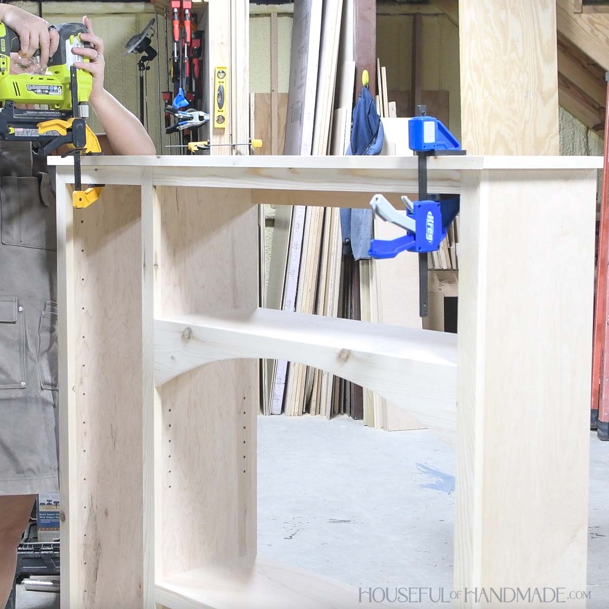 Attaching 1x2 trim to the top of the cabinet. 