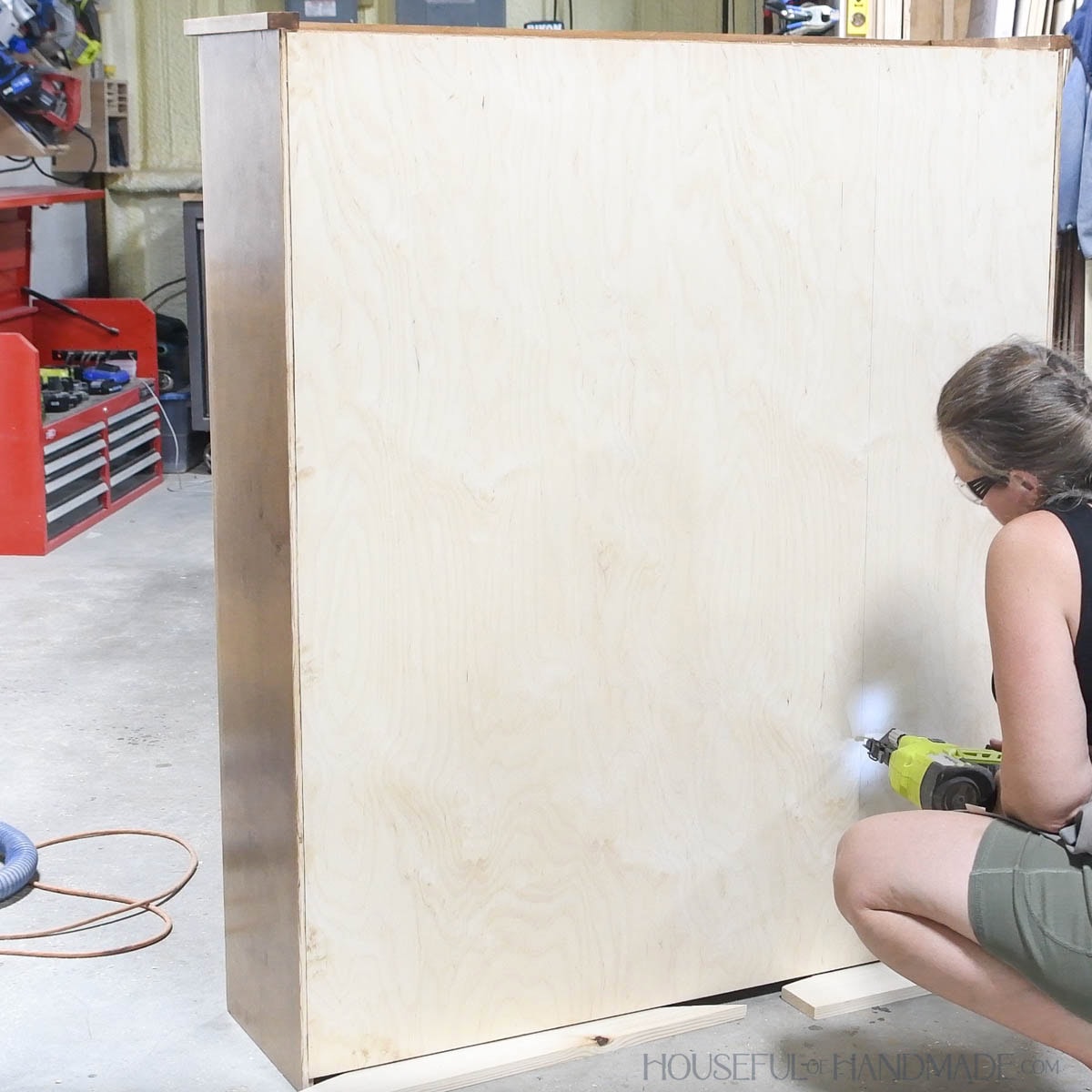Securing back to the cabinet with brad nails. 