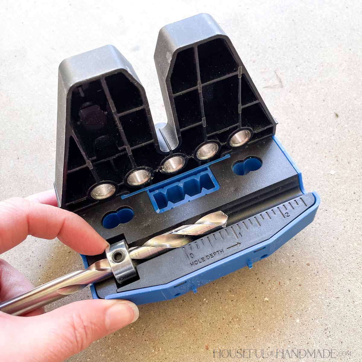 Setting the drill bit depth with the stop collar. 